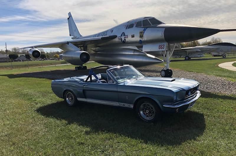 Convertible Mustang with Fighter Jet in Background
